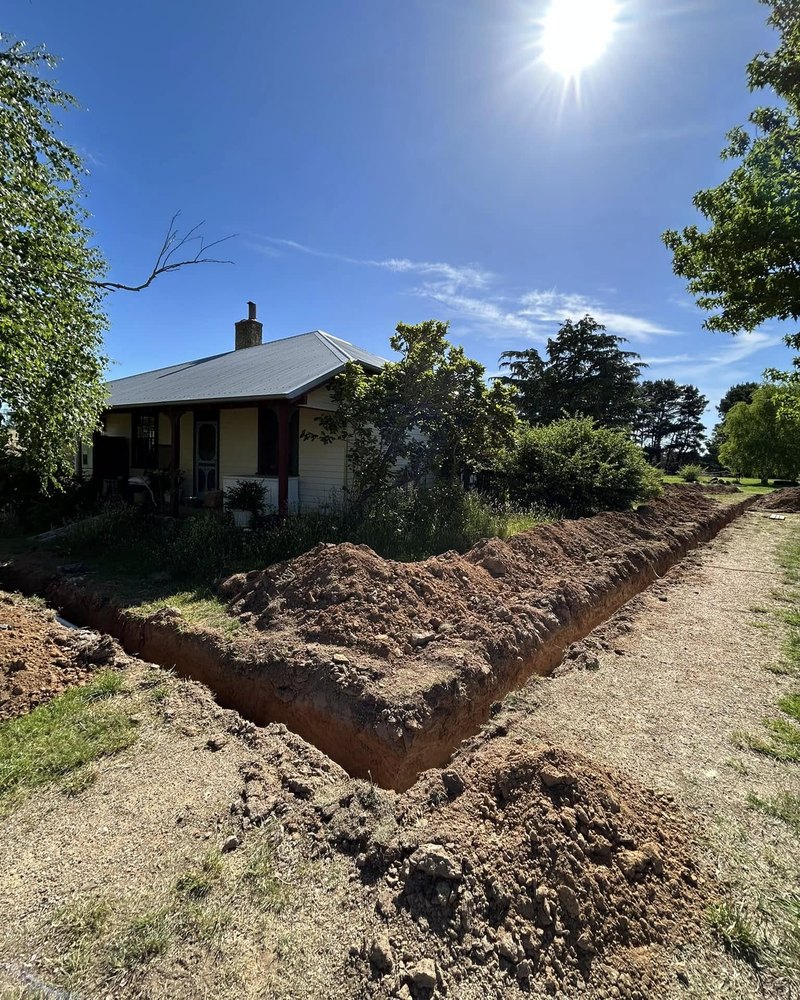 Long Trench Past A Weatherboard Cottage — Brock Plumbing